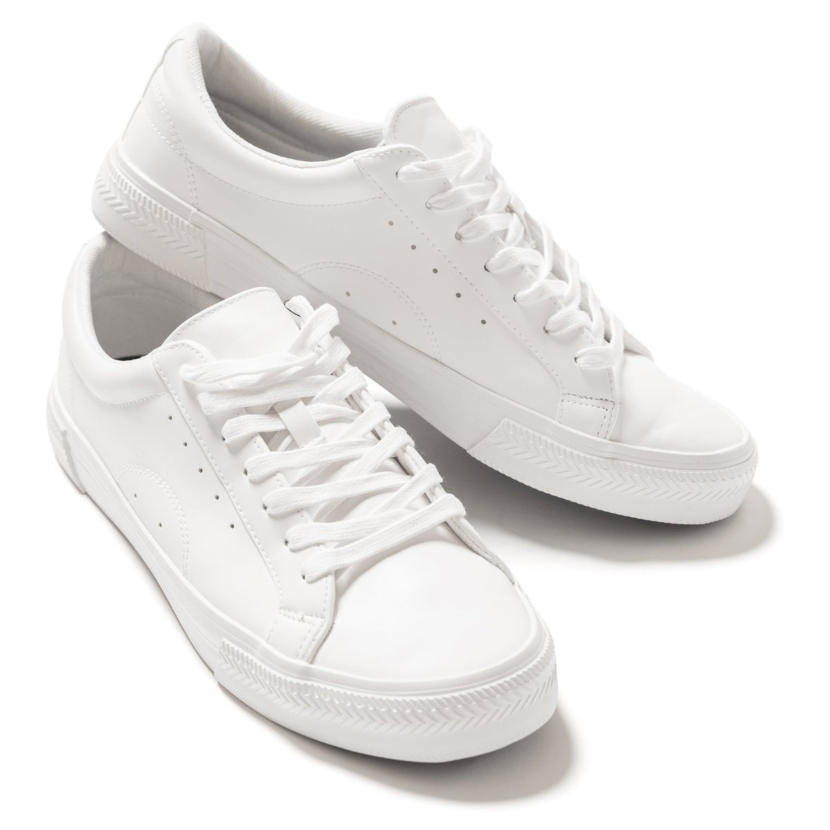 Pair of white leather trainers with shadow