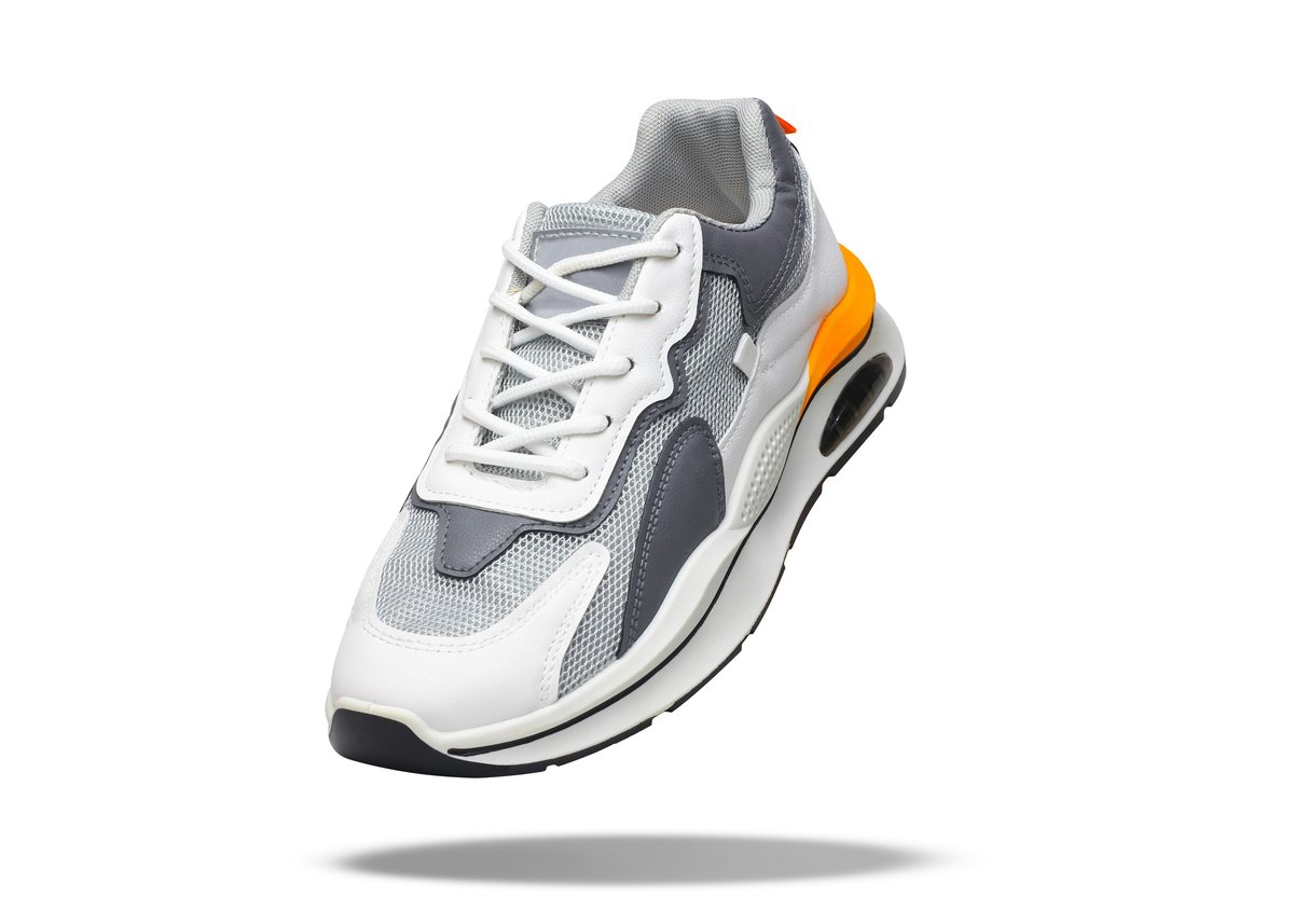 White sneaker levitating on a white background