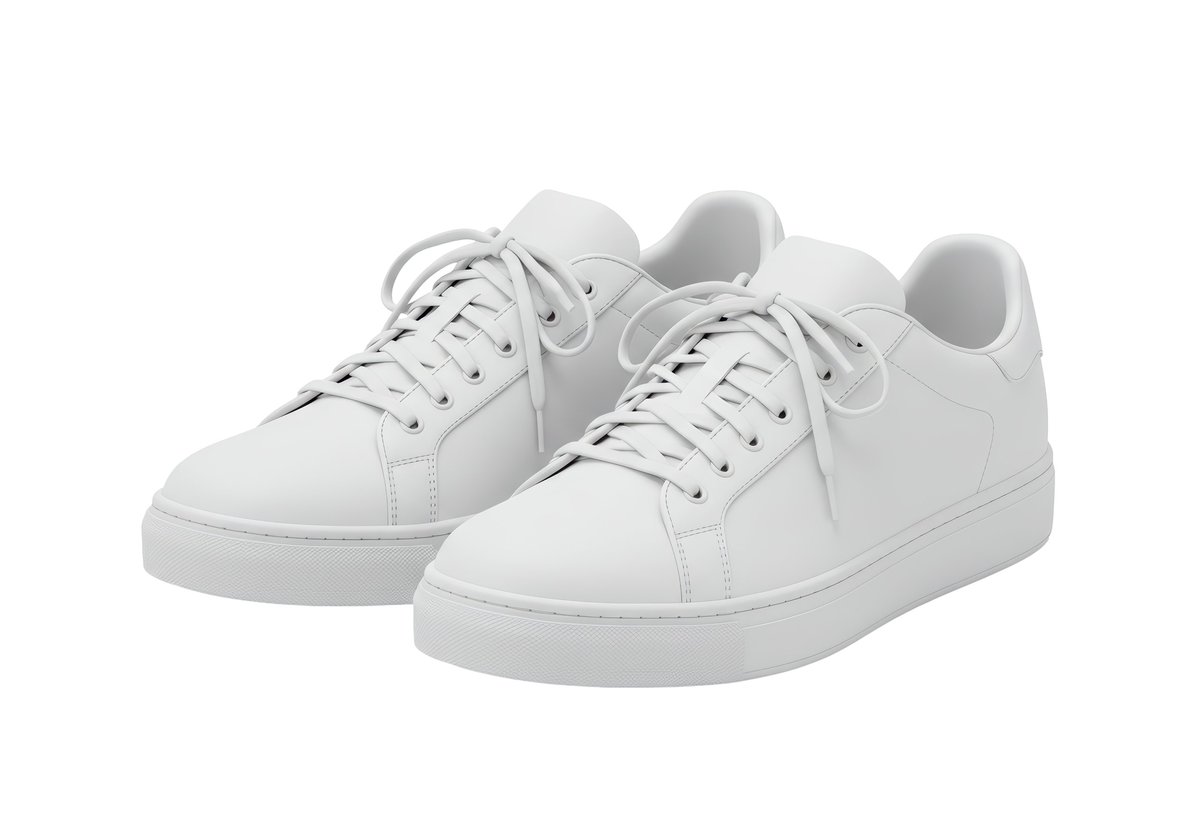 Isolated pair of white sneakers with laces