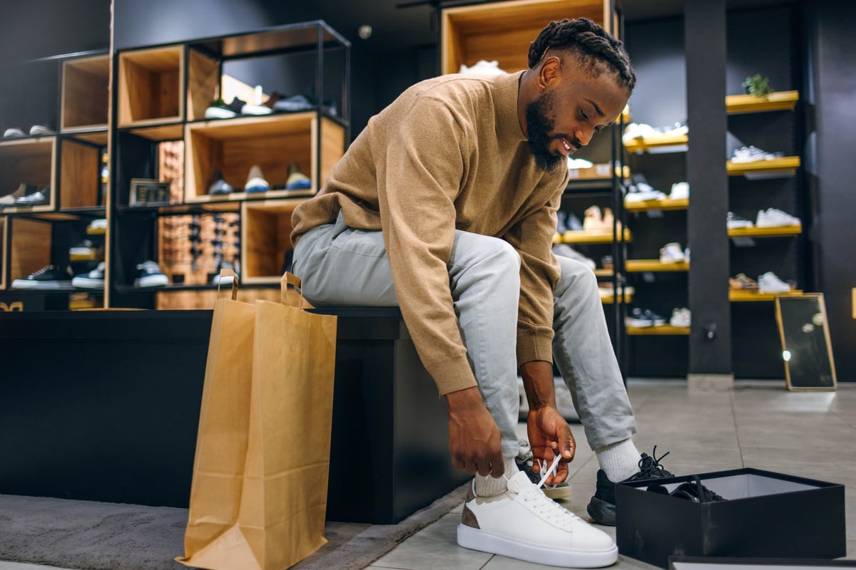 Man trying on a new pair of shoes in a store