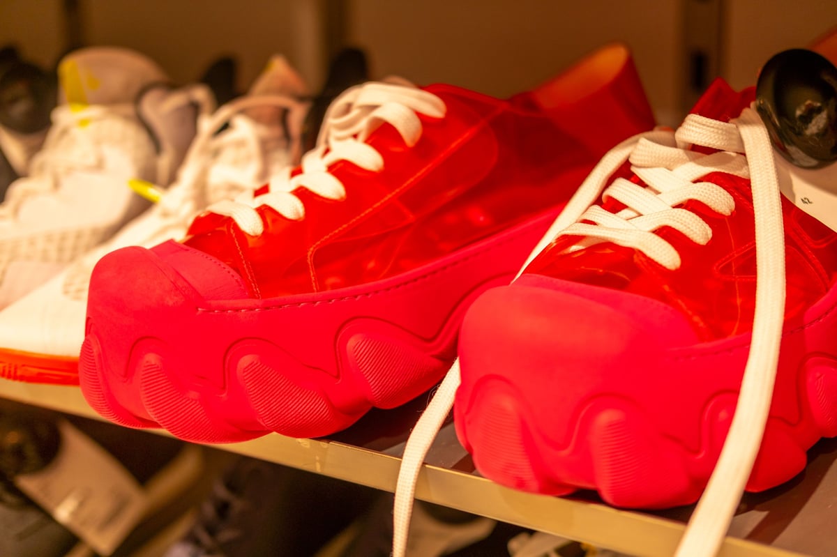 Red sneakers with thick wavy soles on a store shelf