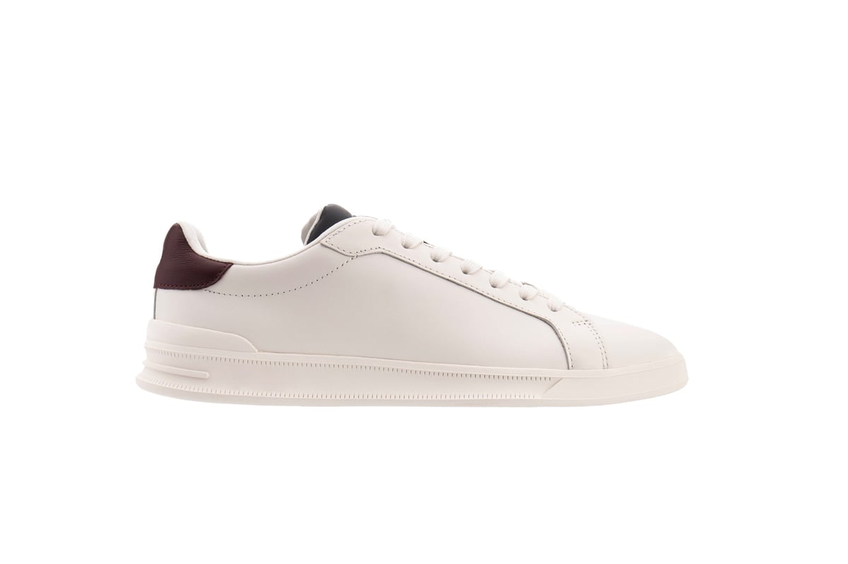 White sneaker with burgundy heel tab in a clean side view