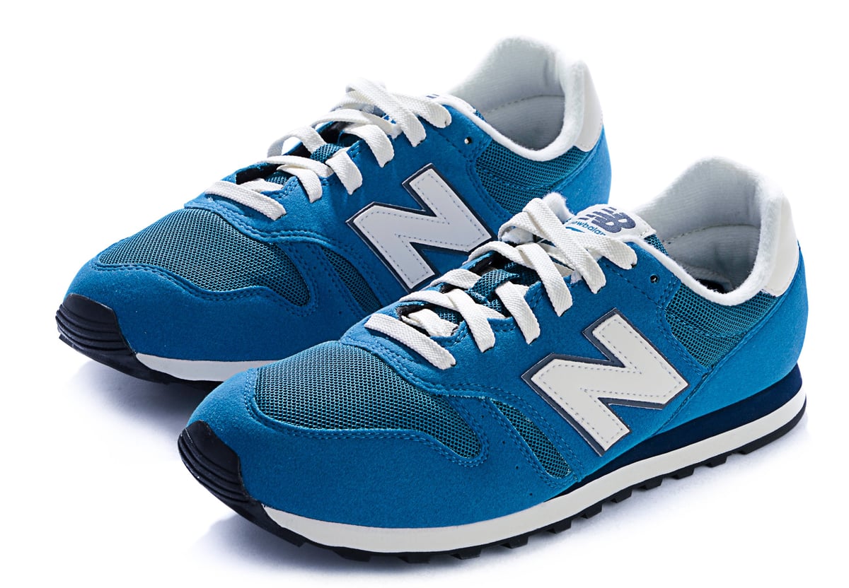 Pair of blue New Balance 373 shoes